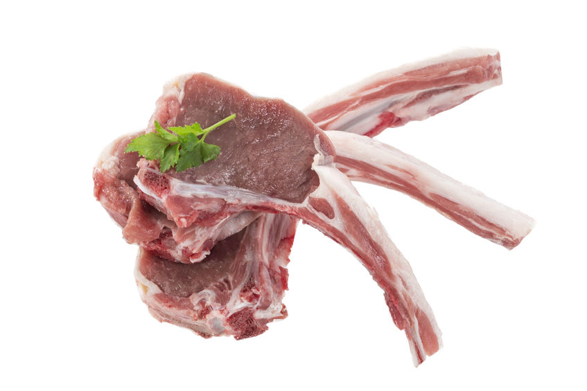 Raw lamb chops on a white background